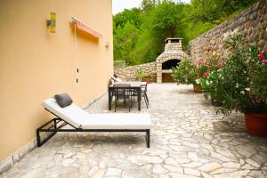 a patio with a couch and a table and chairs at Apartmani Filip i Jakov in Senj