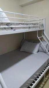 a bunk bed with two pillows on the bottom bunk at RPCB Condo Rental in Cagayan de Oro