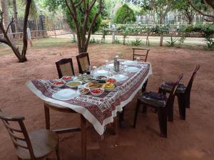 a table with plates of food on it at Aachchi Country Home by ABC Leisure's group in Jaffna
