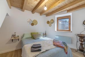 a bedroom with a bed and a window at Casa Do Renque in Arzúa +17 photos
