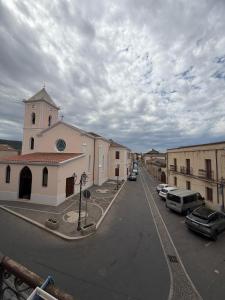 a small church with cars parked in a parking lot at ELEGANCE GIBA Rooms in Giba +1 photo