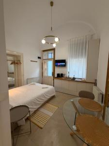 a bedroom with a bed and a table and chairs at AMS Cluj Central Stay Boutique in Cluj-Napoca