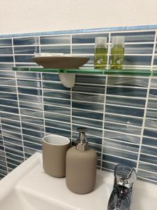a shelf above a sink with two cups on it at ELEGANCE GIBA Rooms in Giba