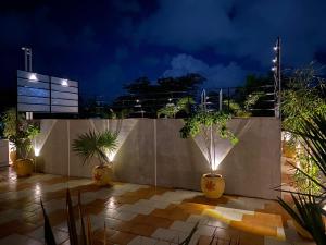 a patio with potted plants and a fence at night at Villa Shakthi in Pondicherry