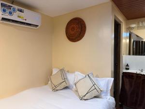 a bedroom with a white bed with pillows on it at Bahay El Nido in El Nido +12 photos