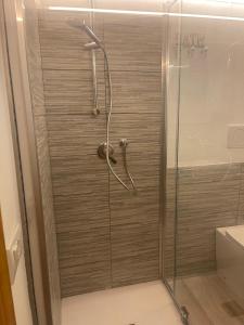 a shower with a glass door in a bathroom at Baita Le Pozze in Abetone