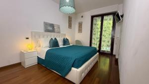a bedroom with a large bed with a blue blanket at Crystal House in Montesilvano