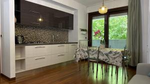 a kitchen with a table and chairs in a room at Crystal House in Montesilvano