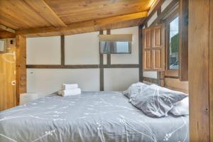 a bedroom with a large bed with wooden ceilings at Cabañita rústica con piscinas in Cambre +19 photos