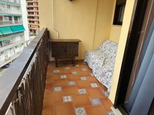 a balcony with a table and chairs on a building at Isla de los Pensamientos in Cullera +2 photos