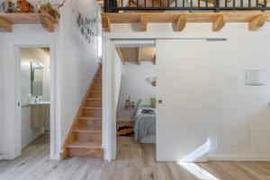a room with a staircase and a bedroom with a bed at Casa Do Renque in Arzúa