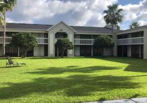 an exterior view of a building with a large yard at Lyrios Vacation Rentals - Legacy in Kissimmee