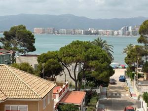 a view of a city and the ocean with buildings at Isla de los Pensamientos in Cullera