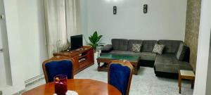 a living room with a couch and a table at Layna in El Mouradia +29 photos