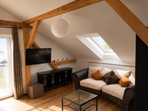 a living room with a couch and a tv at Bad Aibling City Apartment - Pano in Bad Aibling