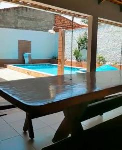 a ping pong table in front of a swimming pool at Suíte Excellence - 01 in Pirenópolis