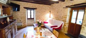 a living room with a couch and a table at Gîte d'Alithe in Montamel +5 photos