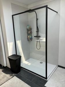 a shower with a glass door in a bathroom at Rhythm & Rest in Boom
