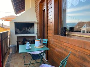 a small table on the balcony of a house at Chalet Iris in Bertigo