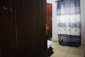 a door leading to a bedroom with a curtain at Chez Kivu in Rubavu