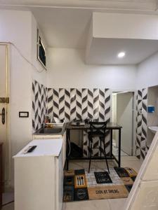 a kitchen with a table in the middle of a room at Djerba Appartement in Houmt Souk