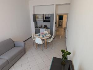 a living room with a couch and a table and chairs at Residence Cosy Baveno in Baveno