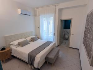 a bedroom with a large bed and a bathroom at Residence Cosy Baveno in Baveno