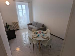 a living room with a table and chairs and a couch at Residence Cosy Baveno in Baveno +18 photos