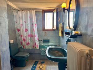 a bathroom with a sink and a toilet and a shower at Zeba apartment 200m from the Sea in Dhílesi +29 photos