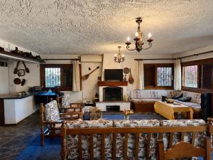 a living room with a couch and a table at Zeba apartment 200m from the Sea in Dhílesi