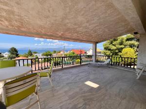 a view from the balcony of a house with a table and chairs at Zeba apartment 200m from the Sea in Dhílesi