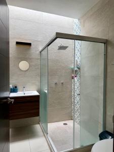 a glass shower in a bathroom with a sink at Manzanillo Homestay Room in Manzanillo