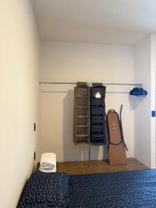 a bedroom with a bed and some shelves at Manzanillo Homestay Room in Manzanillo