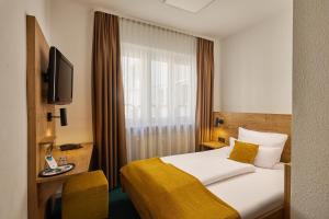 a hotel room with a bed and a window at Hotel Am Markt in Karlsruhe +75 photos