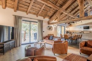a living room with a couch and a table at Chalet de l'epigny in Bellecombe