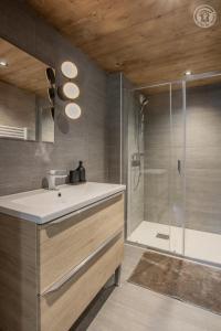a bathroom with a sink and a shower at Chalet de l'epigny in Bellecombe +53 photos
