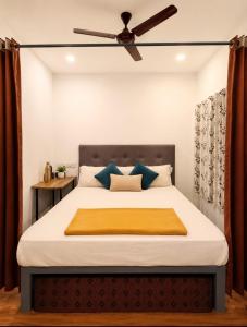 a bedroom with a bed with a ceiling fan at CloudHill Retreat in Ariankāvu