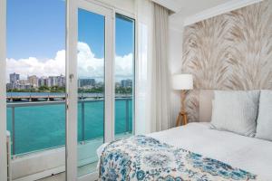 a bedroom with a bed and a view of the water at Premier Ocean Lagoon Studio · Condado with Pool in San Juan +144 photos