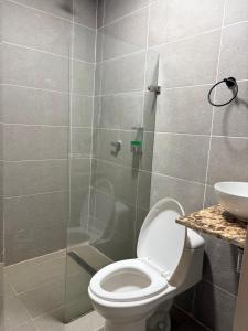 a bathroom with a toilet and a glass shower at cabaña emanuel in Sopetrán +16 photos