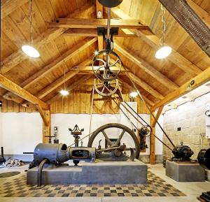an old sewing machine in a room with wooden ceilings at Pivovar Lobeč in Lobeč