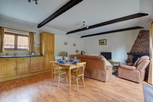 a living room with a couch and a table at 2 Bed in Lyng oc-864 in Lyng +3 photos