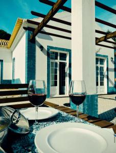 two glasses of red wine sitting on a table at Casa da Lua in Erra