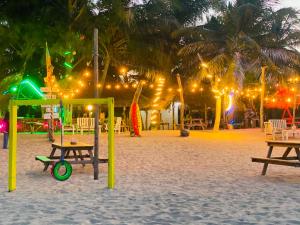 a playground on the beach at night with lights at Happy Beach hotel nilaveli in Nilaveli