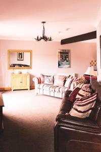 a living room with a couch and a table at Ardbrae Cottage in Daviot