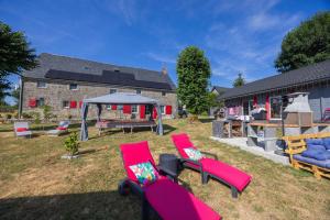 two pink chairs and a playground in a yard at Chambres D'hôtes Histoire D'anges in Singles