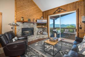 a living room with a couch and a fireplace at Grey Fox in Banner Elk