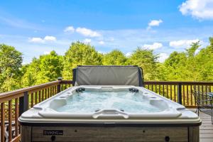 a hot tub on the deck of a house at Grey Fox in Banner Elk