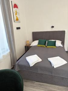 a bedroom with a bed with two towels on it at Willa Pod Platanem in Bytów