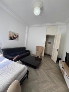 a living room with a bed and a couch at Lafayette Apartment in Tunis