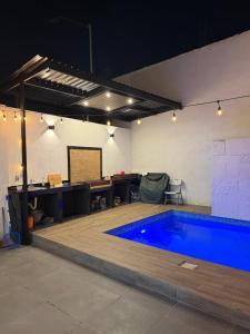 a swimming pool in a room with a table and a desk at Casa Tulipán in Monterrey